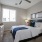 Large well lit bedroom with plush carpets and large windows 