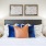 Large well lit bedroom with plush carpets and large windows 