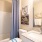 Well lit bathroom with white cabinets