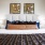 Large well lit bedroom with plush carpets and large windows 