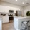 Spacious and well lit kitchen with wood flooring and stainless steel appliances
