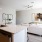 Spacious and well lit kitchen with wood flooring and stainless steel appliances