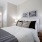 Large well lit bedroom with plush carpets and large windows 