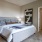 Large well lit bedroom with plush carpets and large windows 