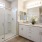 Large well lit bathroom with white accents 