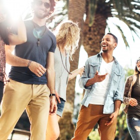 The Carson group of friends walking down the street and laughing